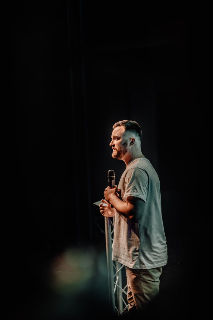 man on stage with a microphone